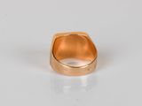 an image of a gold ring sitting on top of a white surface