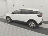 the white car is parked in the garage on the checkered floor