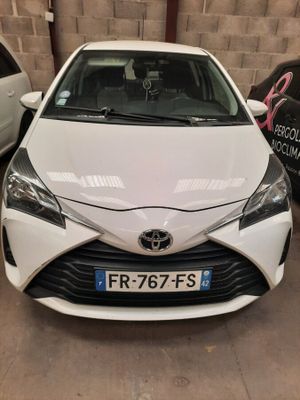 the front of a white toyota yaris parked in a garage