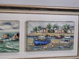 two paintings of boats are hanging on a wall in a room