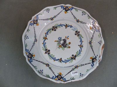 a white plate with blue and yellow designs on it