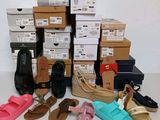 many pairs of shoes that are sitting on a table