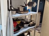 pots and pans on the shelves in the kitchen