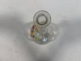 a small glass candle holder on a white table