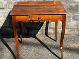 a small wooden table with a drawer on top of it