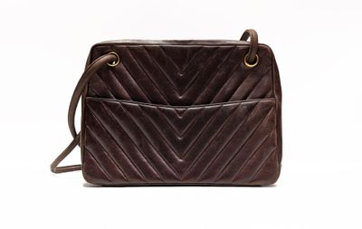 the small brown bag is sitting on a white surface