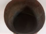 a brown vase that is sitting on a table