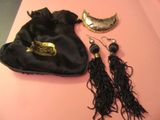 a black bag with a pair of earrings on it