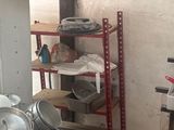 many pots and pans sitting on a shelf in a room