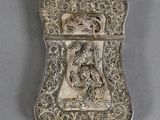 an antique silver cigarette case with a dragon on it