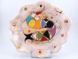 a plate with a colorful design on it on a stand