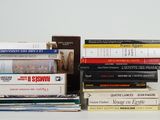 many books stacked on top of each other on a table