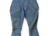 an old pair of blue jeans with buttons on the side of them