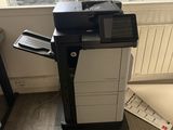 a black and white printer on a stand in front of a window