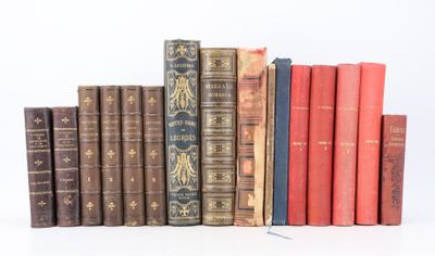 several old books are lined up in a row on a white surface
