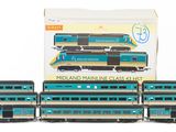 four blue and black train cars sitting next to each other