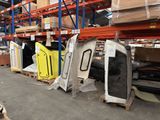 many pieces of furniture in a warehouse with pallets