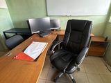 a desk with a chair and a computer on it