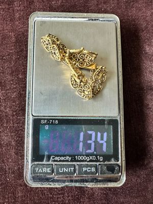 a gold ring sitting on top of a digital scale