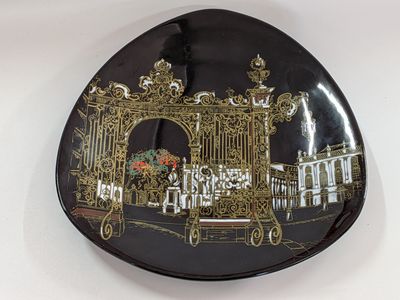 a decorative plate with a picture of a gate on it