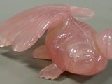 a pink fish that is laying down on a table