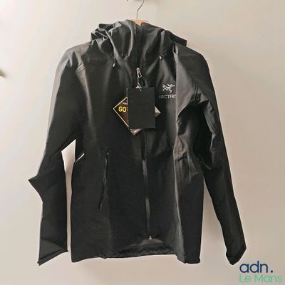jacket hanging on a hanger on a wall in a room