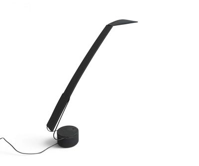 a black lamp that is sitting on a white surface