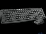 a computer keyboard and mouse sitting next to each other