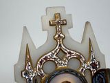 a statue of a woman in a crown with a cross