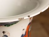 a close up of a white vase with a painting on it