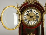 a clock with a magnifying glass in front of it