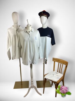 three mannequins and a chair in front of a white wall