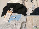 a lot of clothes that are sitting on a table