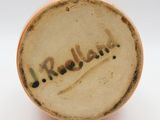 a close up of a vase with writing on it