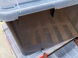 a plastic box with a lid on top of it