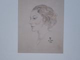 portrait of a woman in profile with a flower in her hair