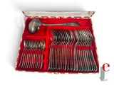 a red box with silverware in it on a white surface