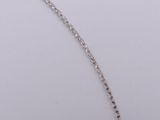 a close up of a silver necklace with a chain on a white surface