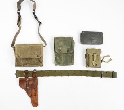 an assortment of military items laid out on a white surface