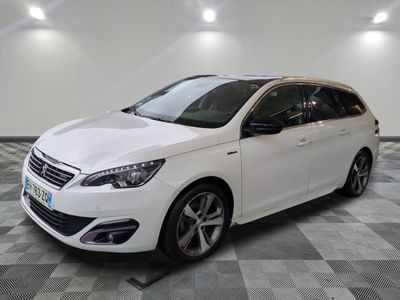 the white car is parked on a checkered floor in the garage