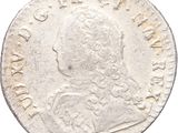 a silver coin with an image of a man on it