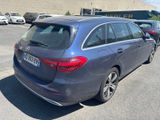 the rear end of a blue mercedes wagon parked in a parking lot