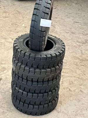 tires stacked on top of each other in a parking lot
