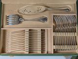 a green box with silverware in it on a table