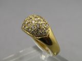 a close up of a gold and diamond ring on a clear surface