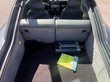 the back of a car with its trunk open and a book in the trunk