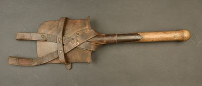 a wooden shovel with a leather handle on a table