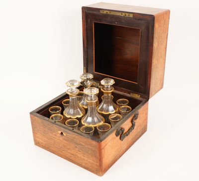 a wooden box that has a set of glasses in it