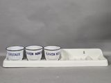 three cups sitting on a tray with a tray underneath them
