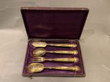 four spoons and a spoon spoon in a purple case